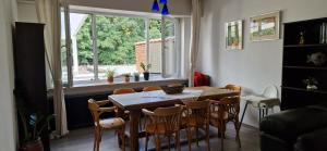 a dining room with a table and chairs and a window at Apartamento de la grotte in Brussels