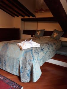 a bedroom with a bed with towels on it at Mazzini 16 in Perugia