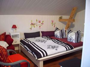 a bedroom with a bed and a red chair at One-Bedroom Apartment in Putbus II in Putbus