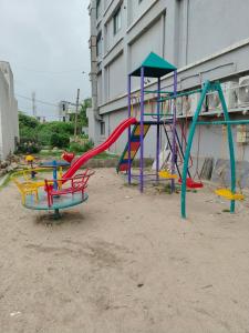 a group of playground equipment in front of a building at The Fero Hotel in Somnath +16 photos