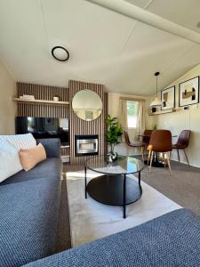 a living room with a couch and a table at Miarlo Lodge Rydal Haven Lakeland in Flookburgh