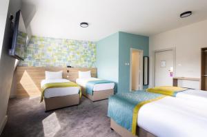 Ένα ή περισσότερα κρεβάτια σε δωμάτιο στο The Camden Street Hotel