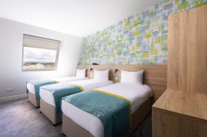 Ένα ή περισσότερα κρεβάτια σε δωμάτιο στο The Camden Street Hotel