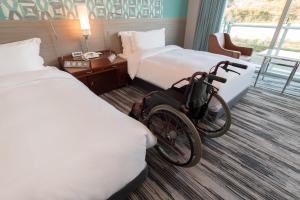 a hotel room with a bicycle parked between two beds at The Prince Park Tower Tokyo - Preferred Hotels & Resorts, LVX Collection in Tokyo