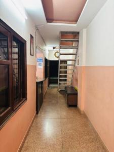 a hallway with a staircase in a room at Ram ji guest house in Parwanoo