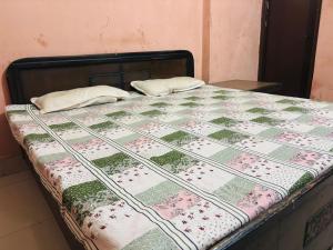 a bed with two pillows on top of it at Ram ji guest house in Parwanoo