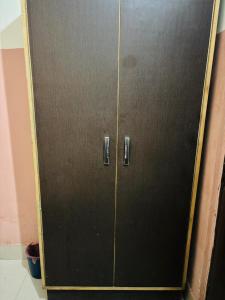 a metal cabinet with two doors in a room at Ram ji guest house in Parwanoo