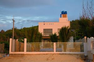 a pink house with a fence in front of it at Sea Sand Garden Villa in Phan Thiet