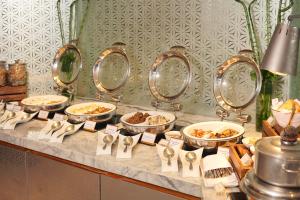a buffet with plates of food and bowls of food at Mandarin Oriental, Jakarta in Jakarta
