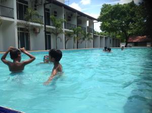 a group of children swimming in a swimming pool at Samwill Holiday Resort in Kataragama +23 photos