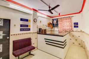 a kitchen with a counter and a chair at SPOT ON Sairaj Lodging & Boarding in Ulhasnagar