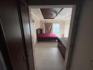 a hallway of a room with a bed and a tub at Pent House in Dargai