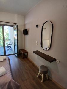 a room with a mirror and a bed and a stool at Αρχοντικό in Megalo Chorio