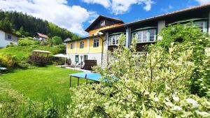 a house with a ping pong table in the yard at Almliesl Gruppenhaus PUCH-625 in Puchenstuben