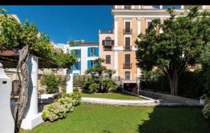 a garden in front of a large building at La Residenza 92 in Gaeta