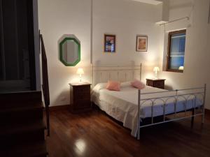 a bedroom with a bed with two night stands and a mirror at La Residenza 92 in Gaeta