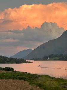 a view of a river with mountains in the background at Slash homestay in Silimapuluh
