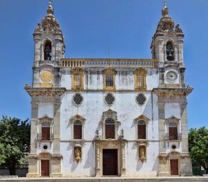 an old building with a clock tower on it at Simply House in Faro +4 photos