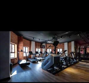 a gym with a bunch of treadmills and a tv at Bedroom flat Caesar resort, Iskele north Cyprus in Vrysoules