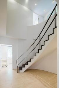 a staircase in a white room with a white wall at Private Beautiful Townhome w Zen Garden in New York
