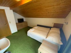 a bedroom with a bed and a sink in a room at Haus Praxmarer in Kaunertal