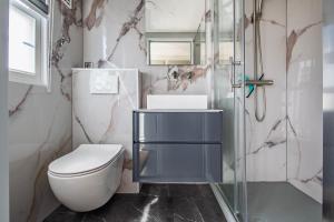 a bathroom with a toilet and a glass shower at 32, Woods, Big Garden, Private Parking , AC & Privacy! in Oisterwijk