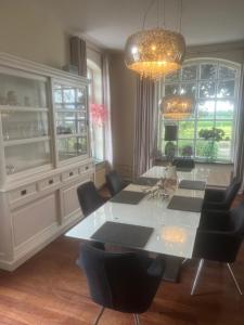 a dining room with a white table and chairs at Annahoeve Venlo, Landhaus 220 qm in Venlo