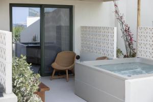 a hot tub in the middle of a house at Cavo Marelia in Amoopi