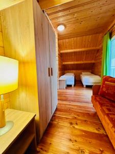 a room with two beds in a wooden cabin at Domki letniskowe Azalia in Ustronie Morskie
