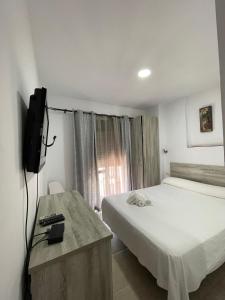 Postel nebo postele na pokoji v ubytování Hostal Malia