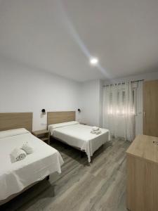 Postel nebo postele na pokoji v ubytování Hostal Malia