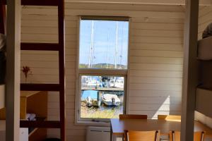 a window in a room with a table and a boat at Aalborg Hytteø in Aalborg