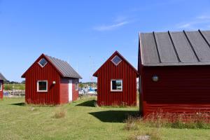 two red buildings are sitting in a field at Aalborg Hytteø in Aalborg