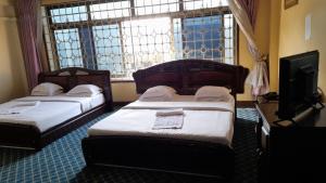 Postel nebo postele na pokoji v ubytování New JBK Hotel