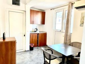 a small kitchen with a table and a dining room at ground apartaments with balcony in Kotor