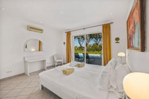 a bedroom with a bed and a desk and a window at Vale Do Lobo Resort in Vale do Lobo