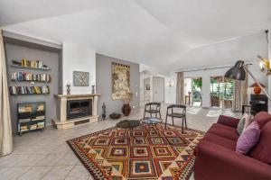 a living room with a couch and a fireplace at Vale Do Lobo Resort in Vale do Lobo