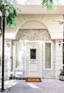 a front door of a house with a brick wall at Athina Loft in Alexandroupoli