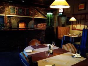 a dining room with two tables with wine glasses at Klawer Hotel in Klawer