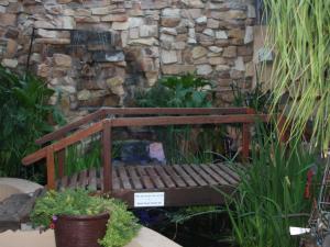 a wooden bench sitting in front of a stone wall at Klawer Hotel in Klawer