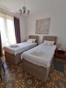 a bedroom with two beds and a chandelier at Villa Nada in Zadar
