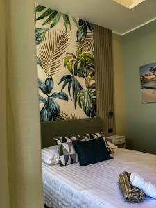 a bedroom with a bed with a painting on the wall at Burgi's House in Pizzo