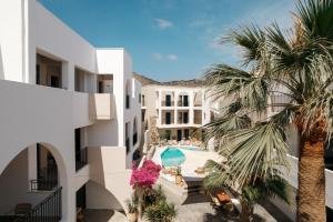 a view of the courtyard of a hotel with palm trees at Nami Hotel & Suites in Stalís