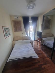 Postel nebo postele na pokoji v ubytování Alisea - Camere in villa con Piscina e parcheggio gratuito + 40 fotografií