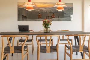 a dining room table with chairs and a laptop on it at Ferienhaus Daheim in Sankt Peter