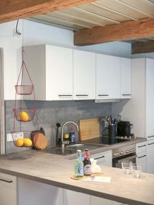a kitchen with white cabinets and a sink at Ferienwohnung 1, Schlaf-Gut-Johannis, Flensburg in Flensburg