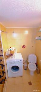 a bathroom with a washing machine and a toilet at Armira House in Nea Moudania +35 photos