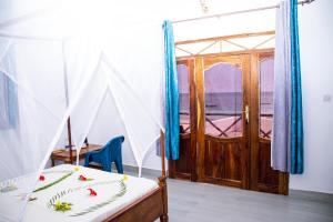 a bedroom with a bed with a view of the ocean at Amazing Beach Hotel Zanzibar in Nungwi