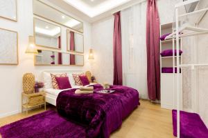 a purple bedroom with a bed and bunk beds at Stylish Studio Collection Central Budapest in Budapest