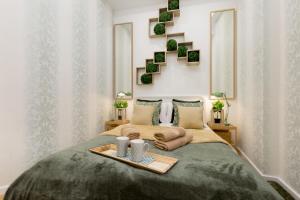 a bedroom with a bed with a tray on it at Stylish Studio Collection Central Budapest in Budapest +86 photos